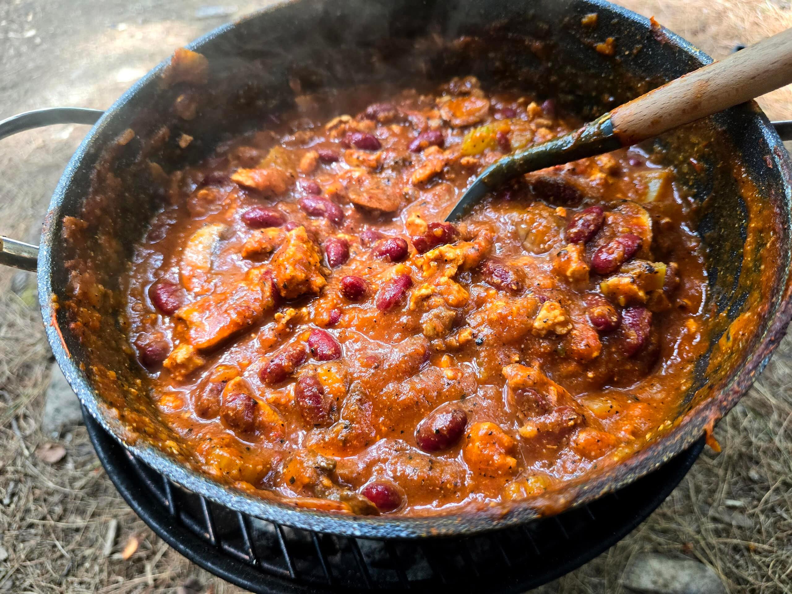 Ingredients for bold campfire chili laid out on a rustic wooden table