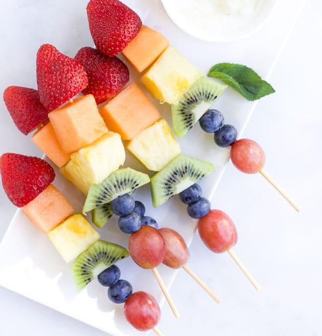 Close-up of a single fruit kebab, showcasing the variety of fruit and colorful presentation