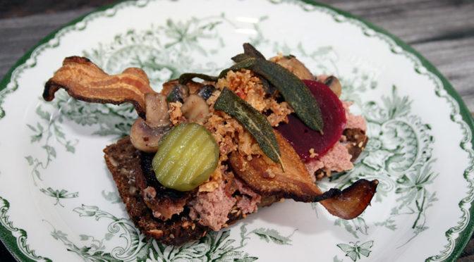 Liver Pâté Smørrebrød with Pickled Beetroot & Bacon on a wooden board