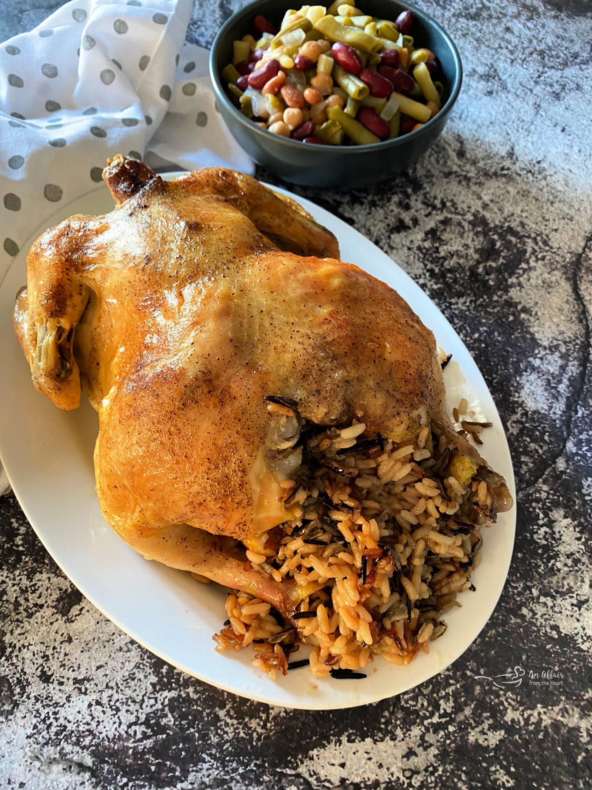 Juicy roasted chicken with golden brown stuffing spilling out