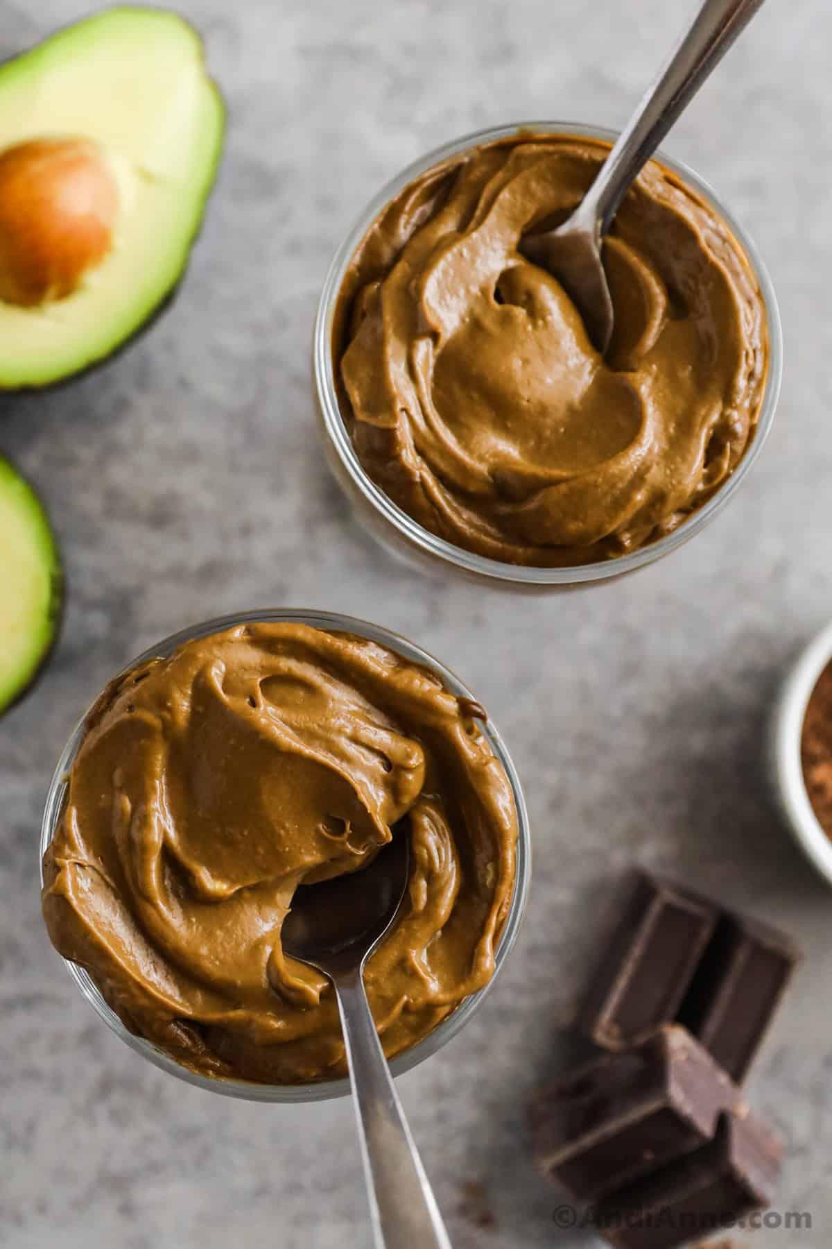 avocado halves beside a bowl of chocolate