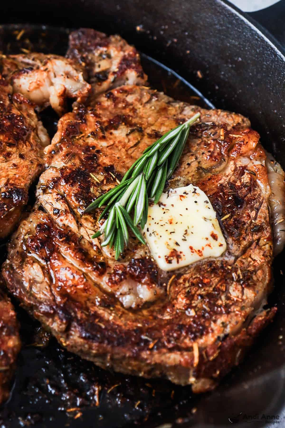 Close-up of a sizzling steak in a skillet, slightly seared