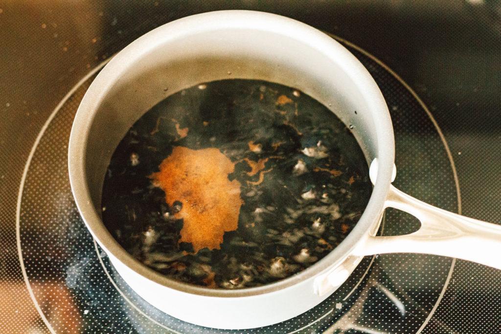 close up shot of simmering fig balsamic reduction in saucepan