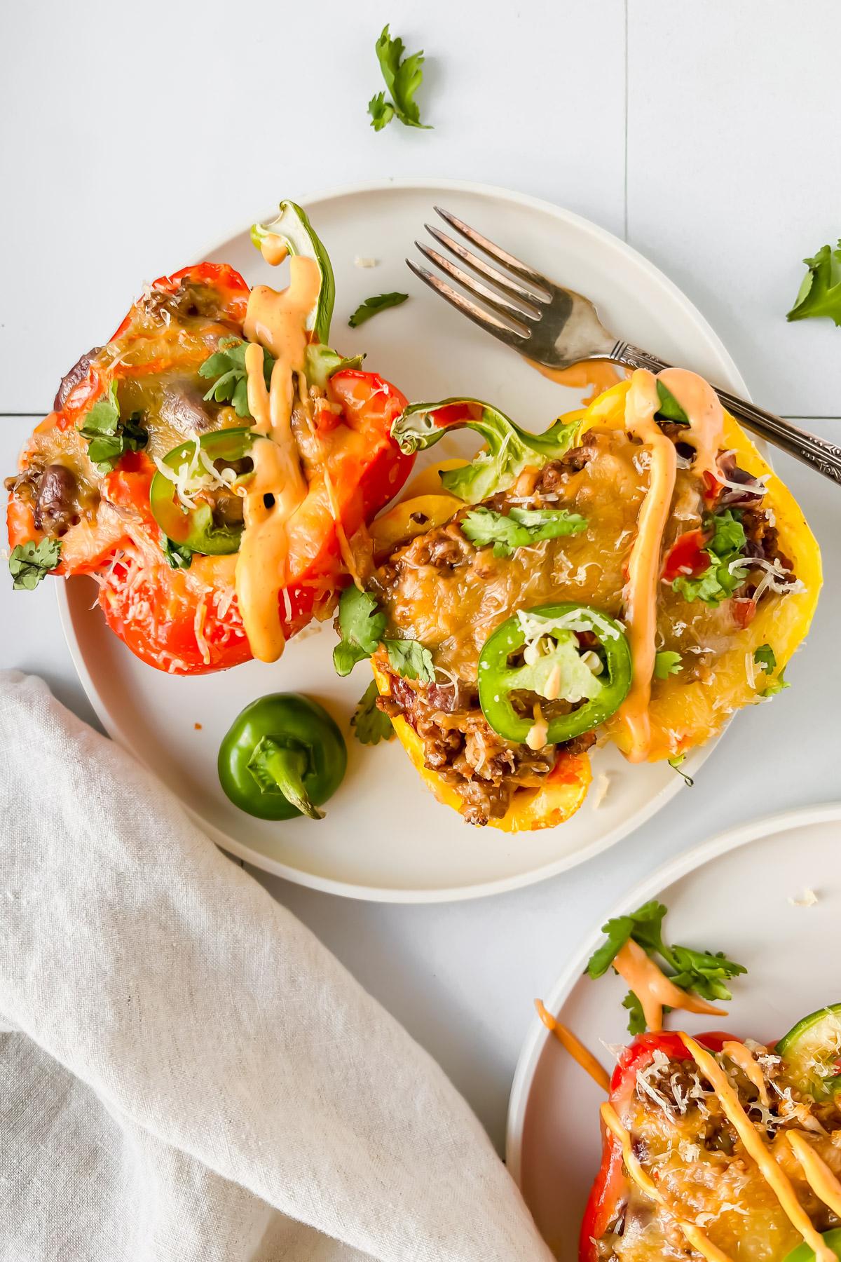 Tortilla Española stuffed inside colorful bell peppers, served on a rustic plate