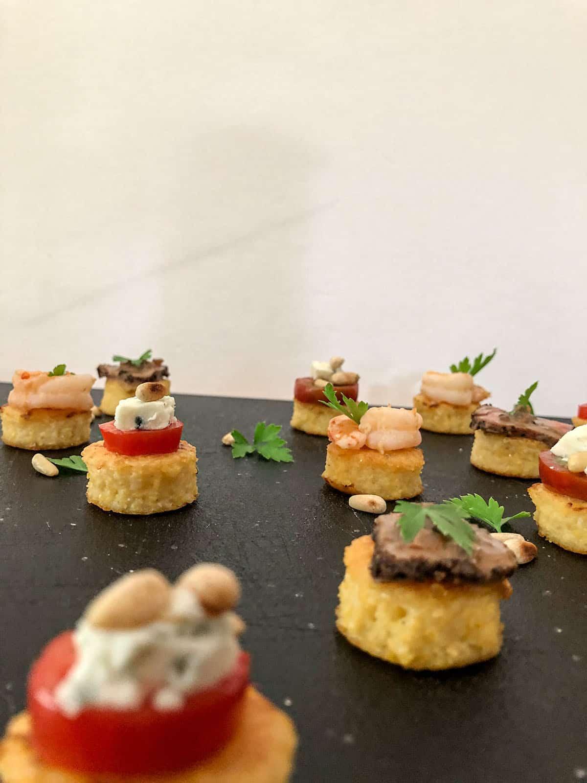 polenta cakes topped with various toppings