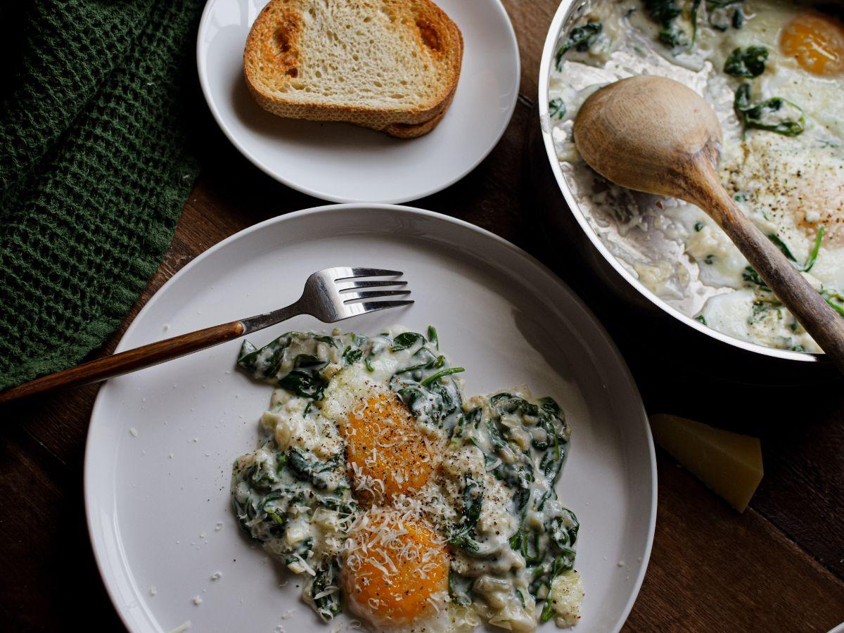Mediterranean Florentine Egg Skillet on a rustic wooden table