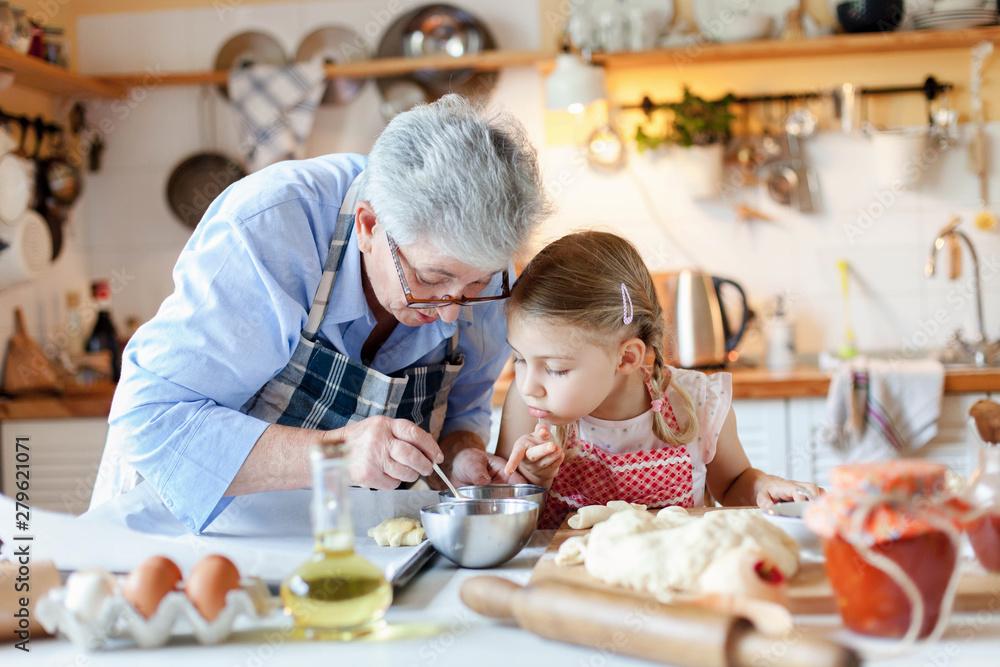 vintage photo of grandmother making hot chocolate with a child, cozy kitchen
