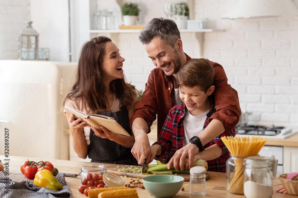 warm, inviting kitchen scene with family laughing and a roast cooking in the background