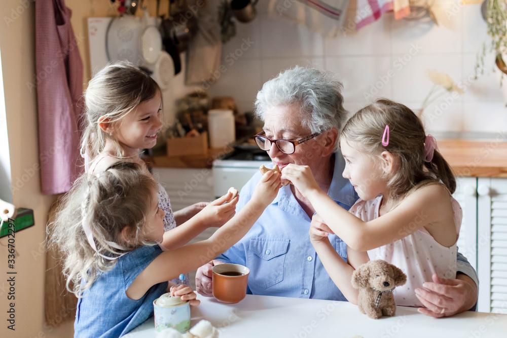 Vintage photo of a grandmother and grandchild baking mini tarts together, cozy kitchen