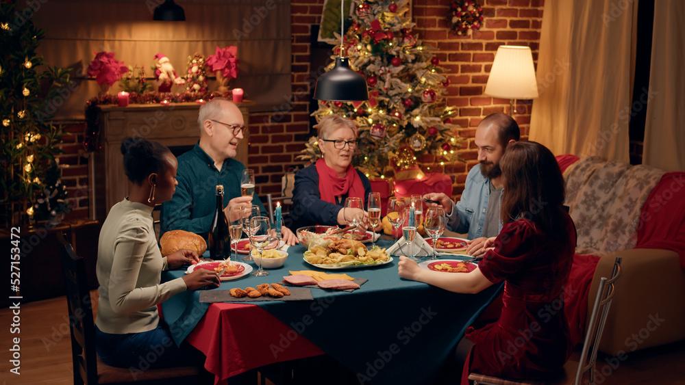 Family gathered around a table with Coquito glasses, festive decorations and laughter