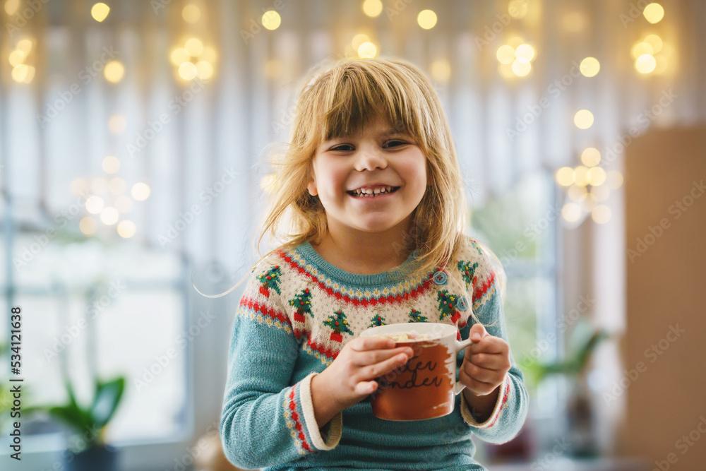 Child happily sipping hot chocolate with orange zest