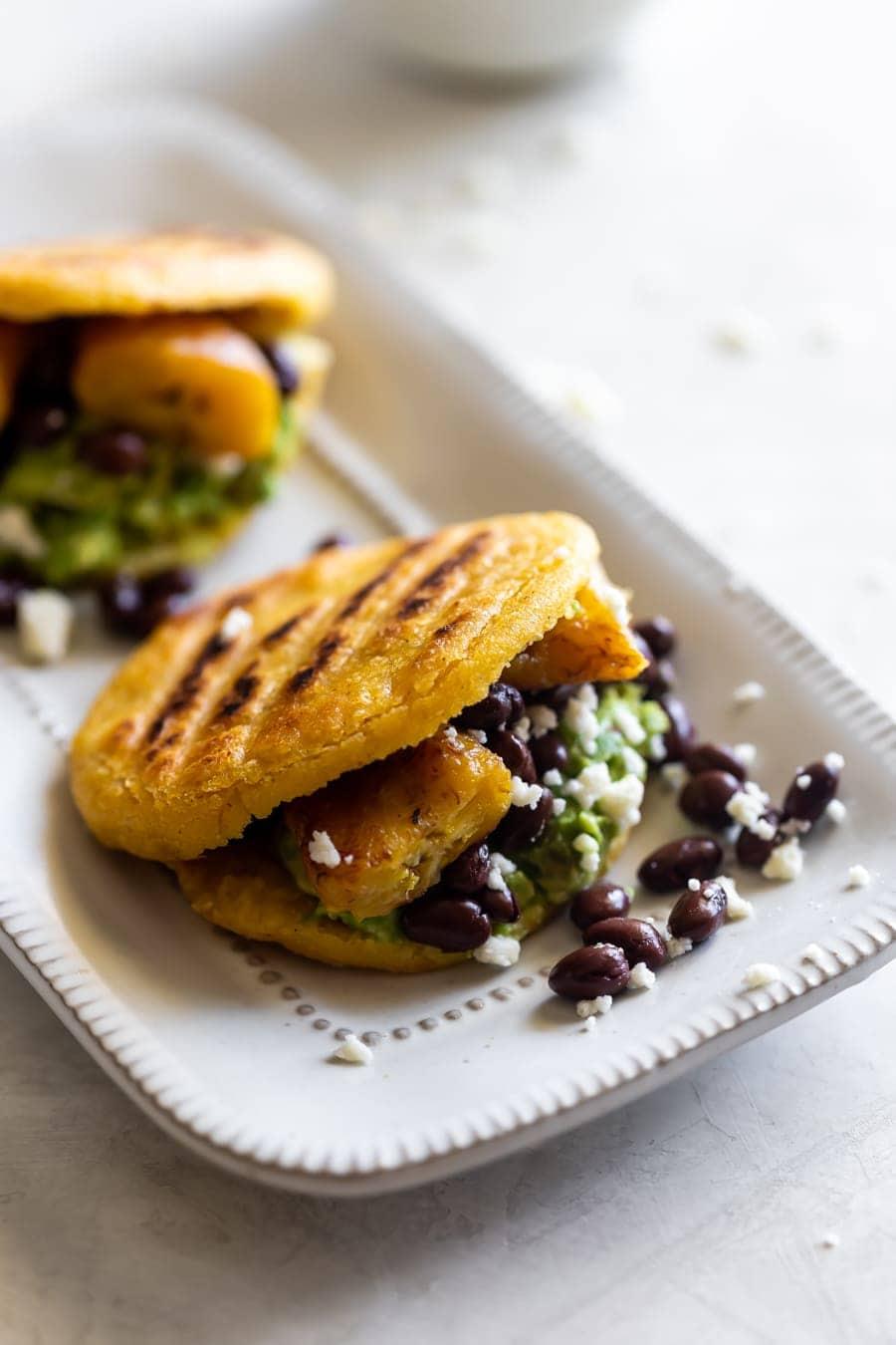 Close-up of a freshly cooked sweet plantain arepa, showcasing its golden-brown exterior and slightly caramelized edges