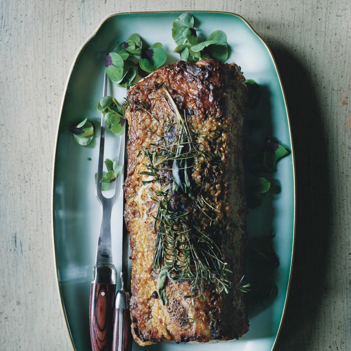 a delicious roasted pork loin with rosemary sprigs