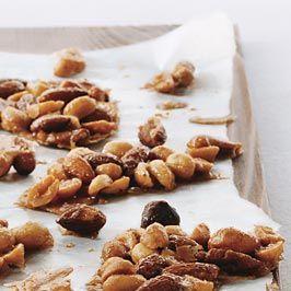 homemade nut clusters with toasted nuts and golden syrup on parchment paper, close-up, warm lighting