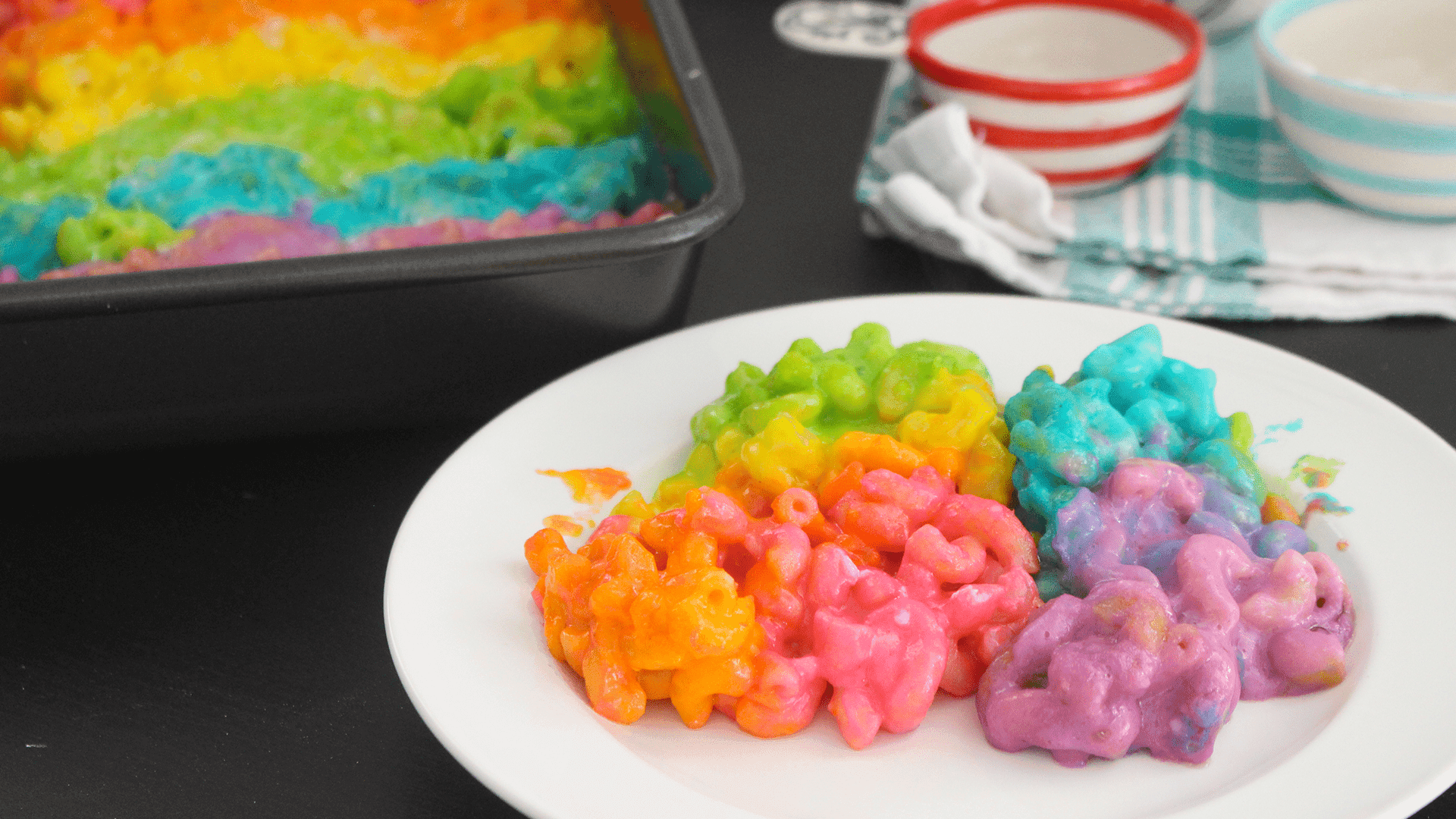 rainbow colored mac and cheese in a baking dish, colorful and vibrant