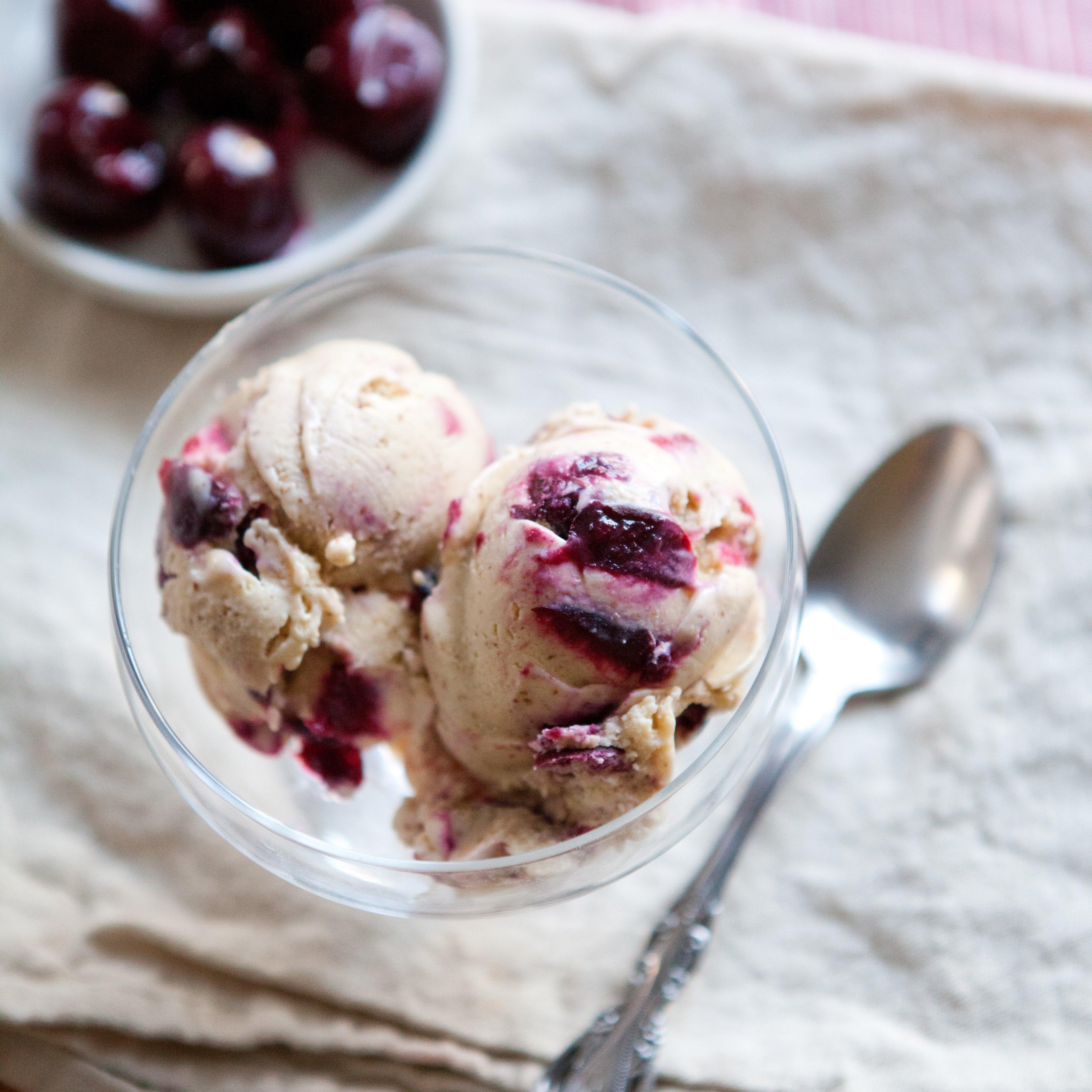 close up of cherry almond ice cream with visible cherry pieces and almond slivers