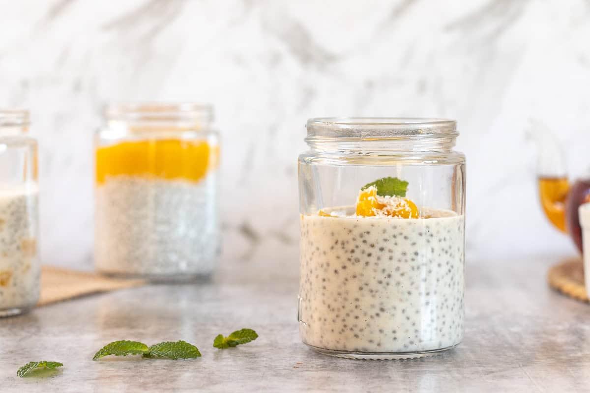 bright and colorful mango coconut chia pudding in a glass jar