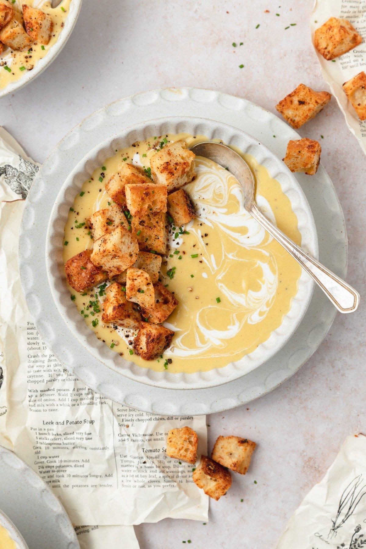heartwarming creamy potato leek soup with buttery croutons, rustic setting