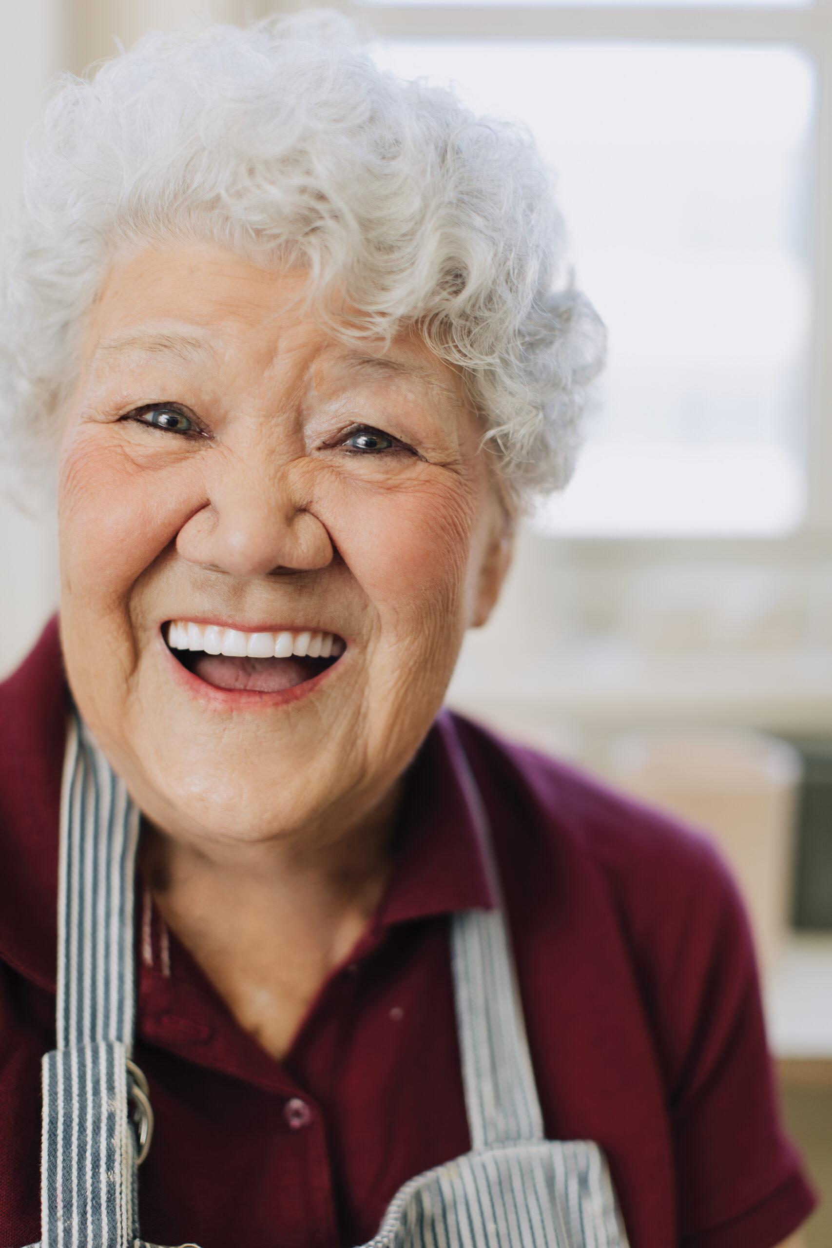 Overhead shot of a person looking stressed but then smiling after taking a bite of a breakfast burrito, sunlight streaming in