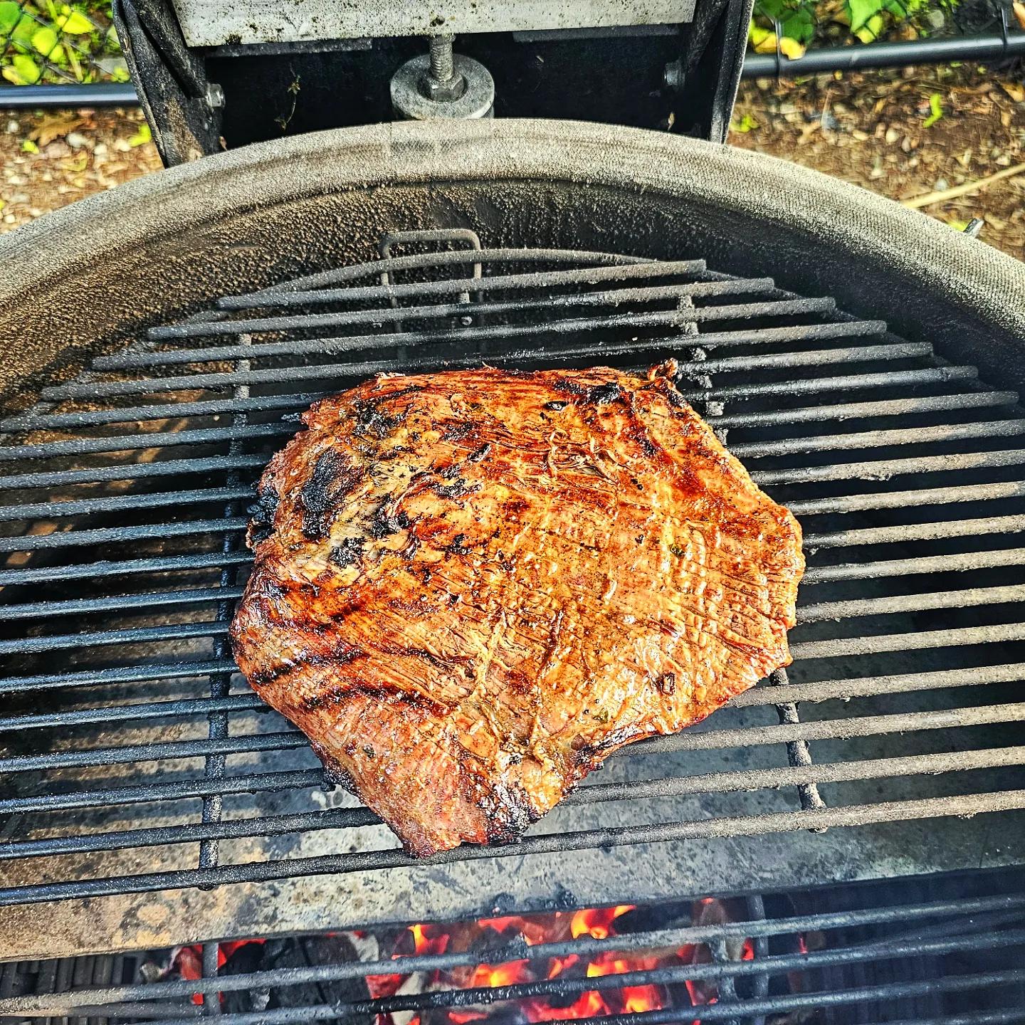 close up of perfectly cooked carne asada on a grill
