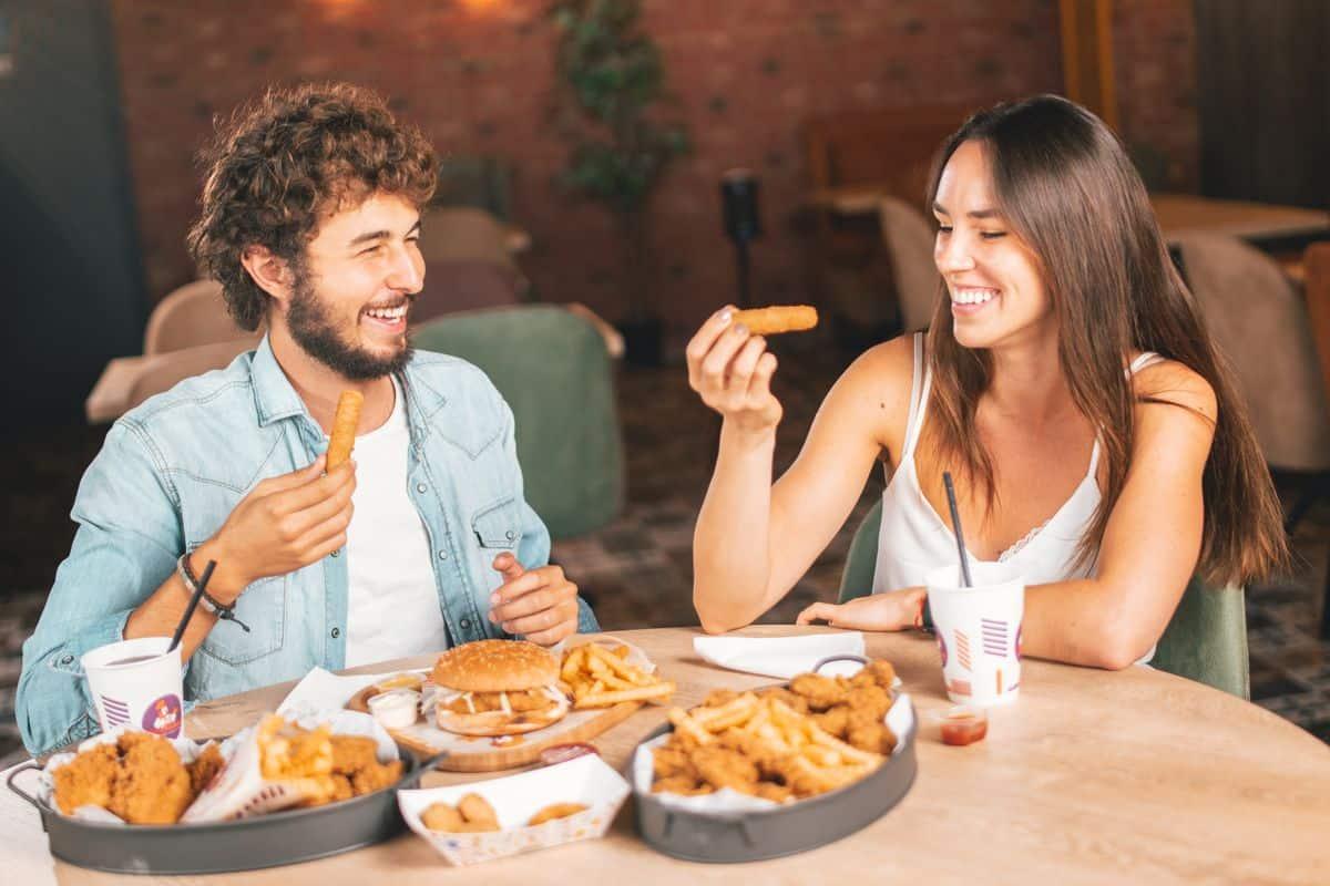 A family enjoying a plate of chicken nuggets
