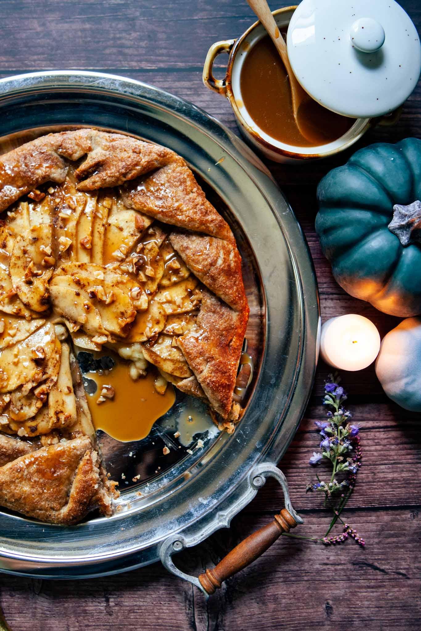 slices of apple pumpkin brie galette on a rustic wooden table