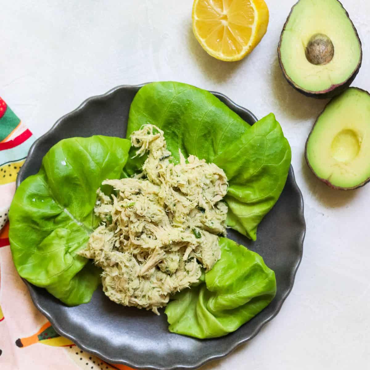 a keto avocado salad being served on a bed of lettuce with a fork
