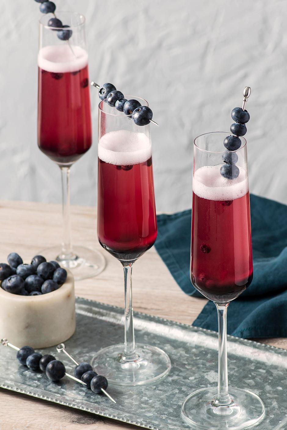 cilantro blueberry mimosa in champagne flutes