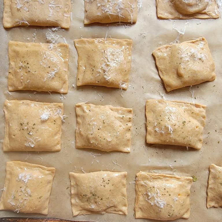 homemade batch of pizza rolls on parchment paper