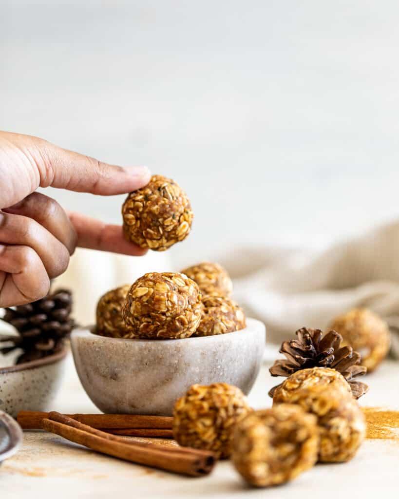 A hand holding a chai spice energy bite