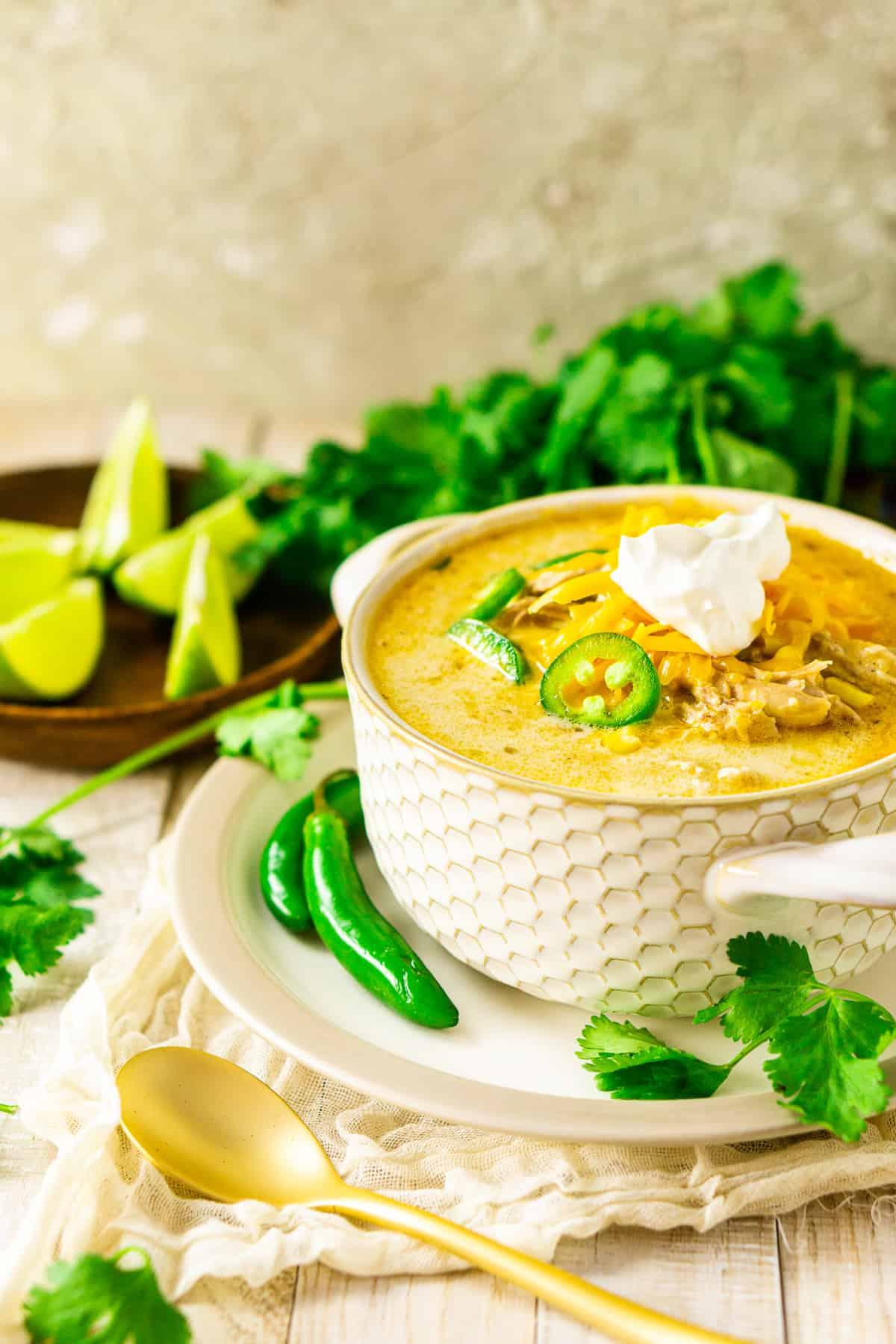 hearty bowl of creamy white chicken chili with fresh cilantro and lime