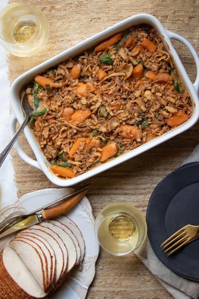 homey Thanksgiving table setting with green bean casserole front and center