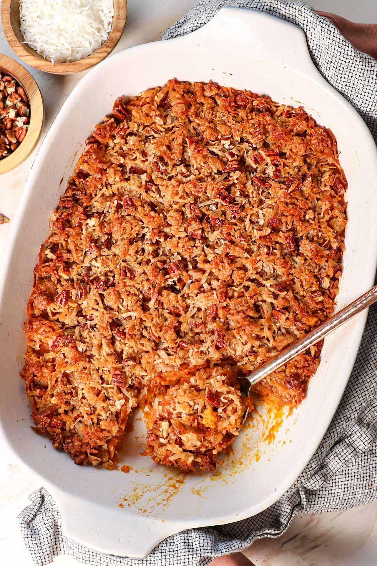 Close-up of golden brown toasted coconut flakes on top of sweet potato casserole