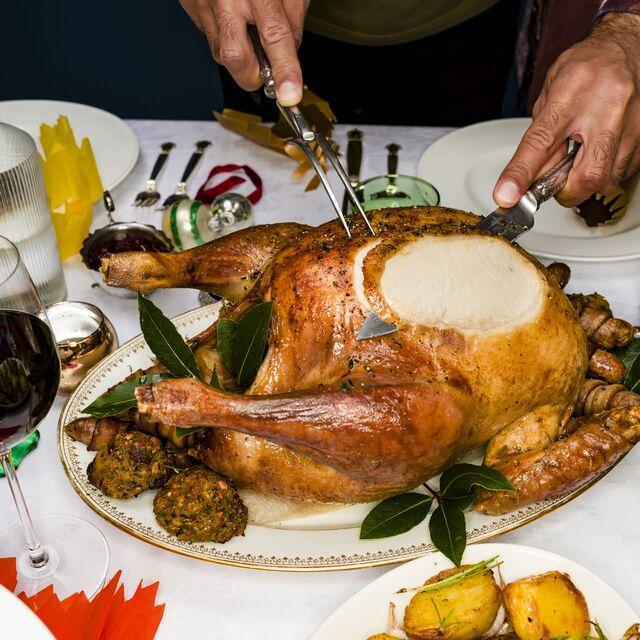 beautifully roasted peppercorn crusted turkey on a festive table with sides, golden brown skin, succulent meat