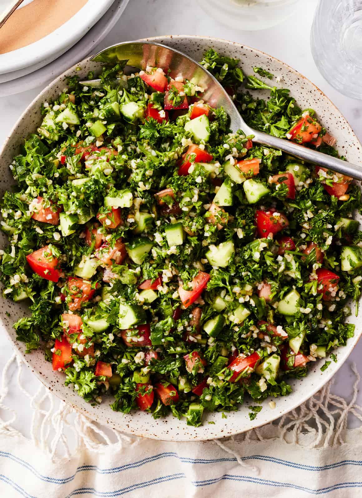 Close-up shot of the ingredients for rustic tabbouleh, showcasing the fresh herbs and whole grains