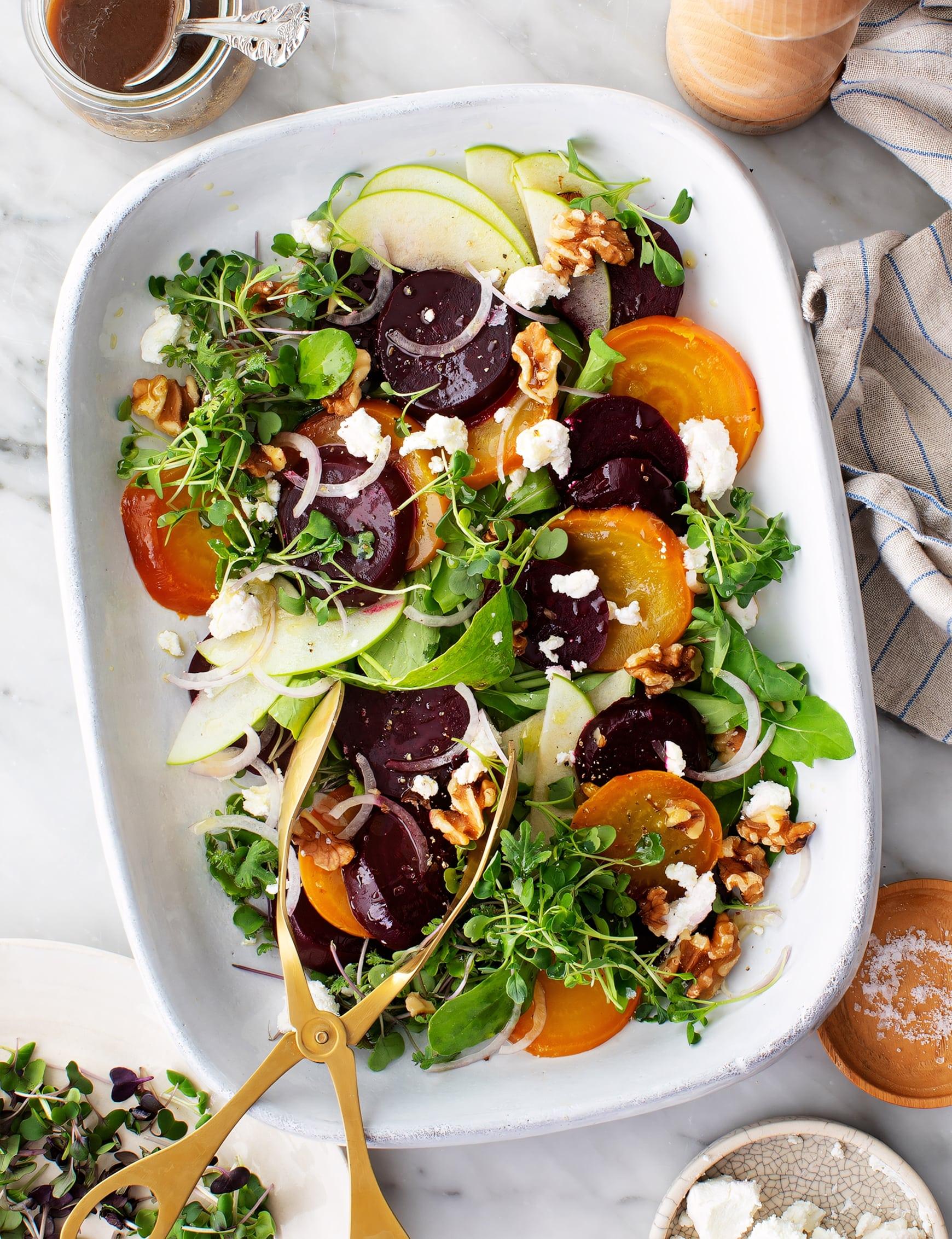 close up of a vibrant mâche salad with beets and goat cheese drizzled with balsamic vinaigrette