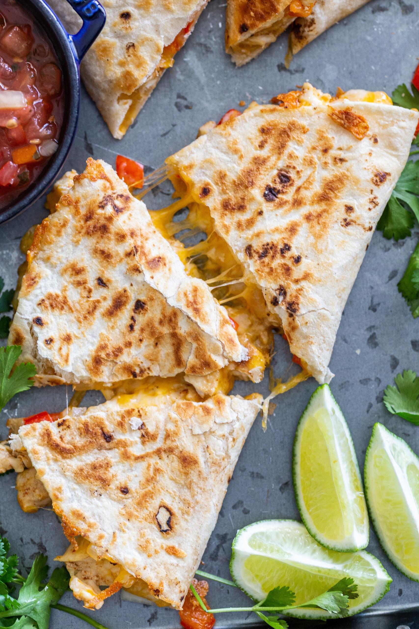 A family enjoying delicious chicken quesadillas around a table
