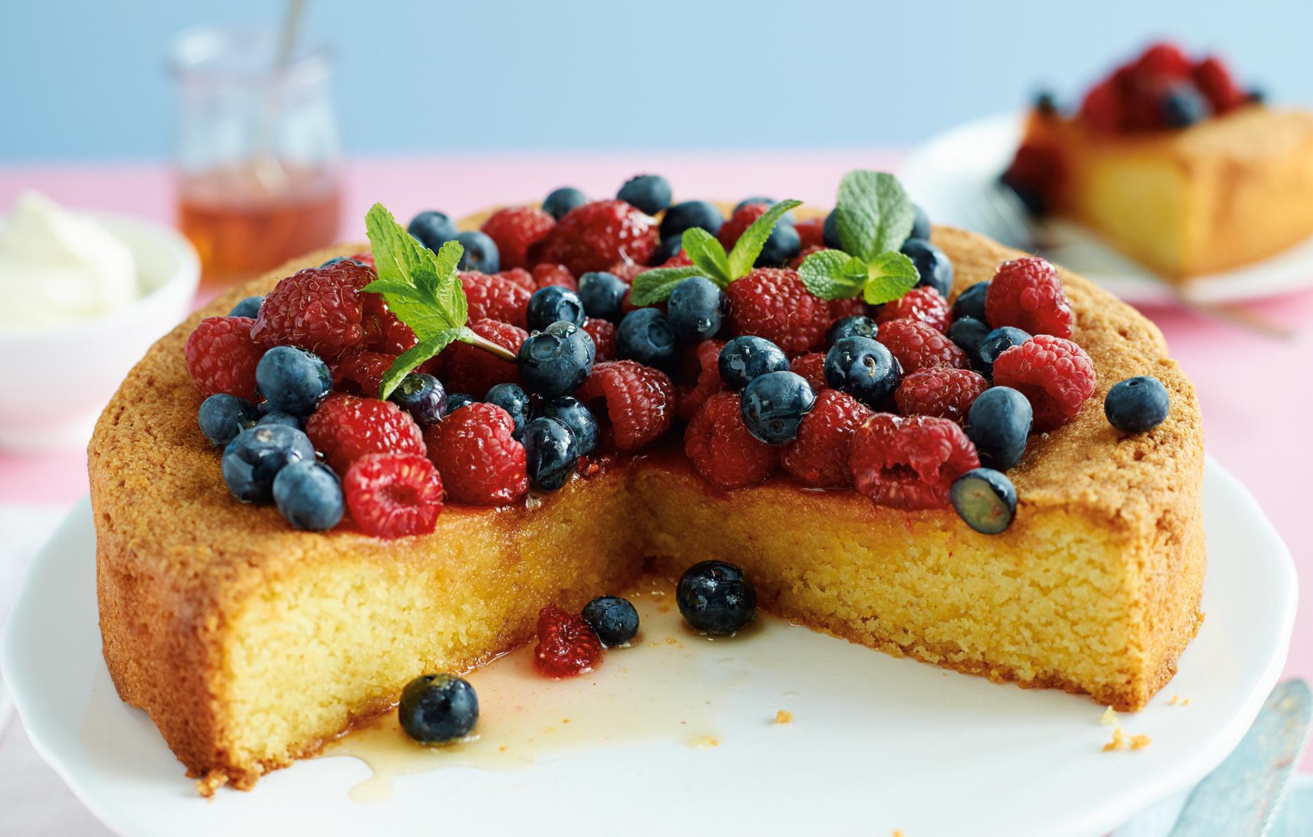 toasted coconut polenta cakes with fresh berries and honey drizzle