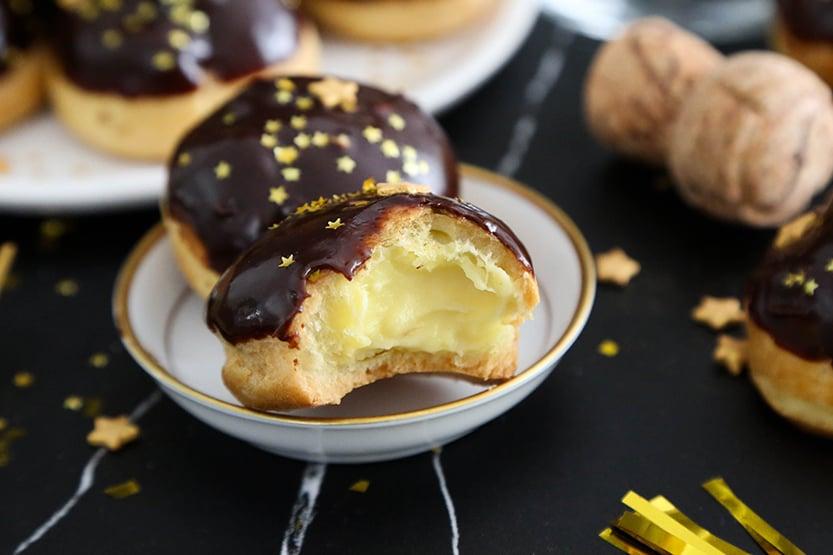 golden choux pastry puffs filled with champagne-infused ganache, served on a celebratory platter