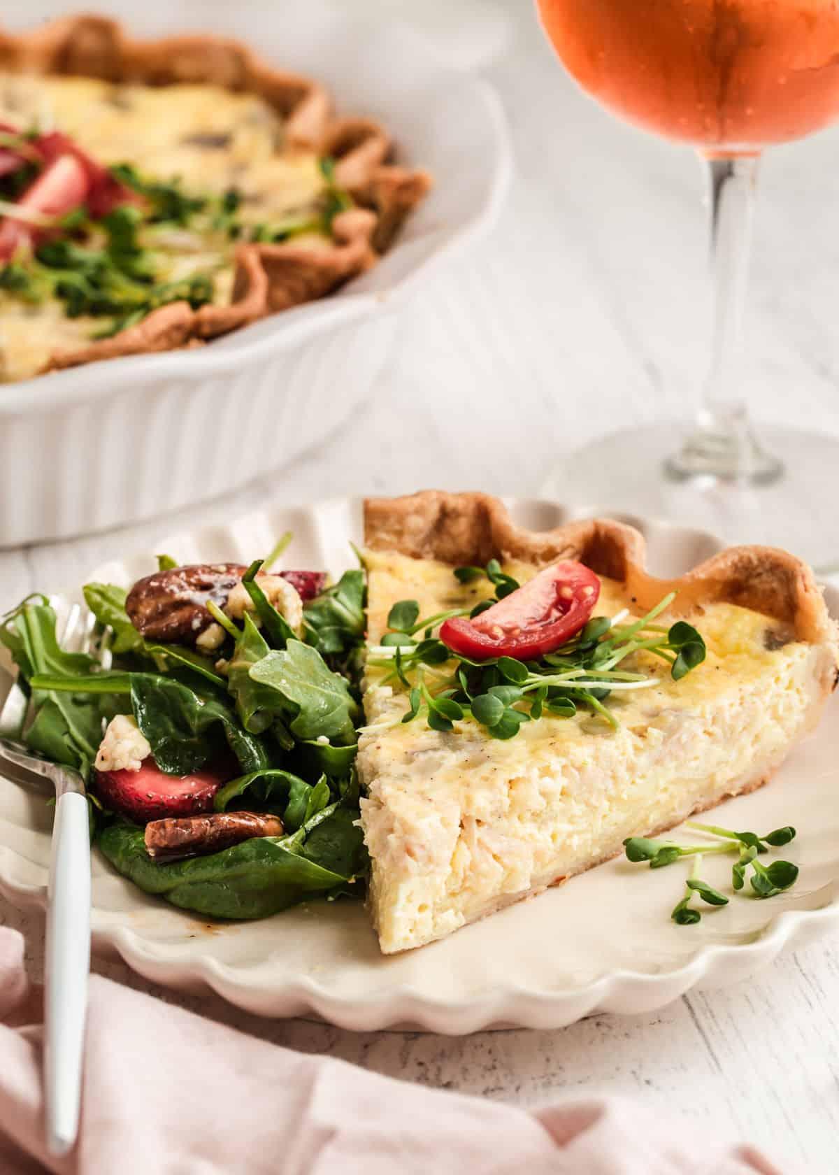 slice of chicken and mushroom quiche with a glass of white wine