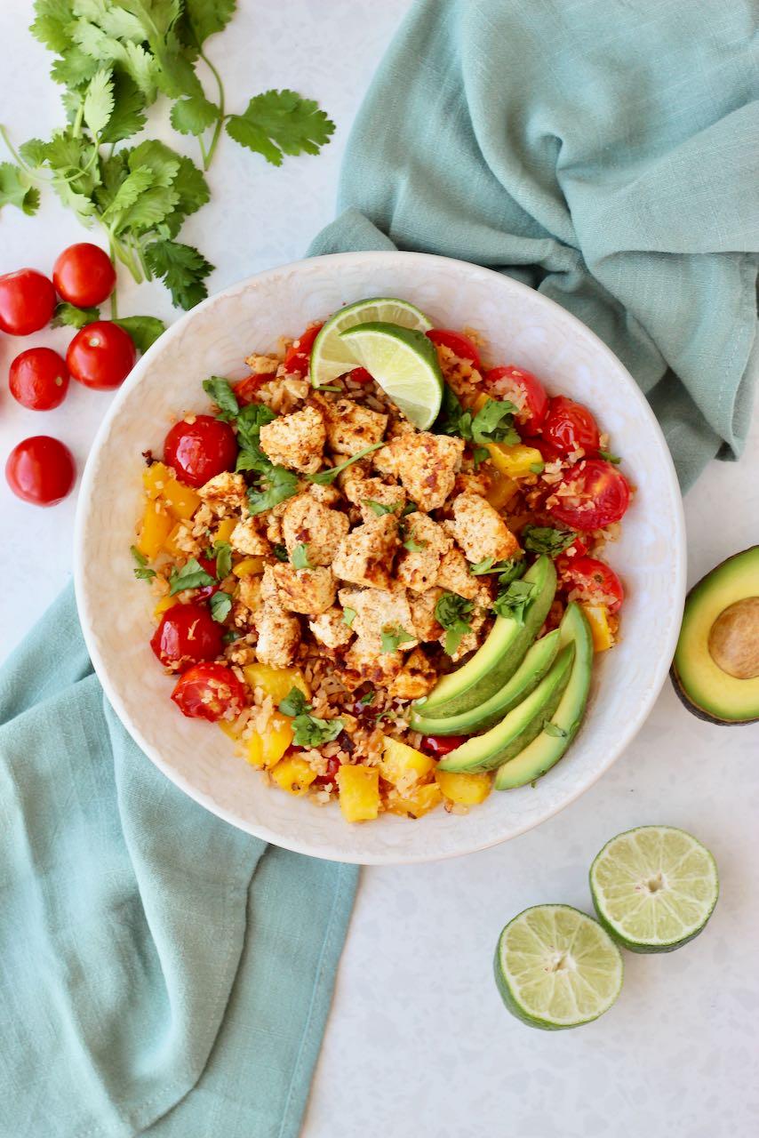 Overhead shot of a vibrant Curried Chicken & Cauliflower Rice Protein Bowl