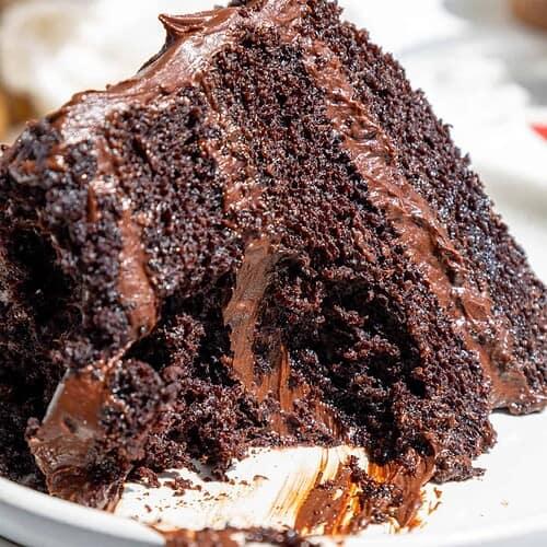 close-up shot of a slice of Birthday Corpse Reviver Cake, revealing its moist texture