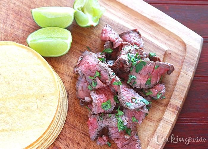 close up tequila lime marinade pouring over steak