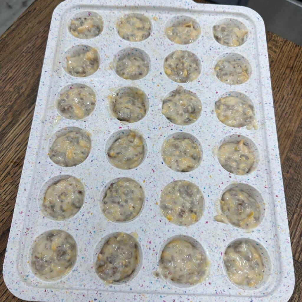 Overhead shot of assembled McGriddle bites on a baking sheet, ready for the oven