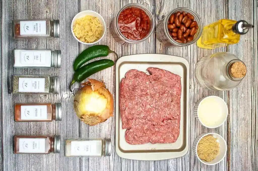 ingredients for texas chili laid out on a wooden table