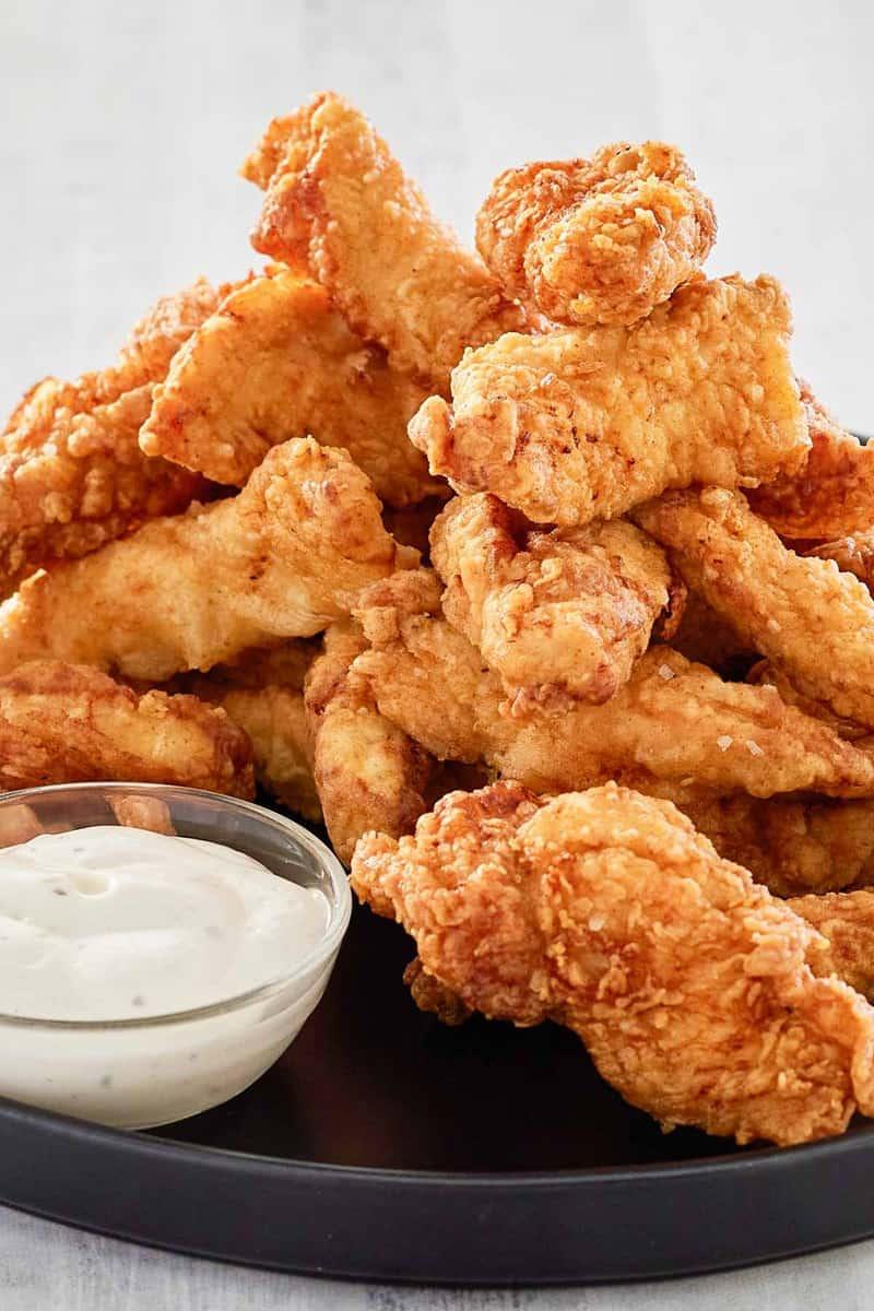crispy beer battered fried chicken on a pub table