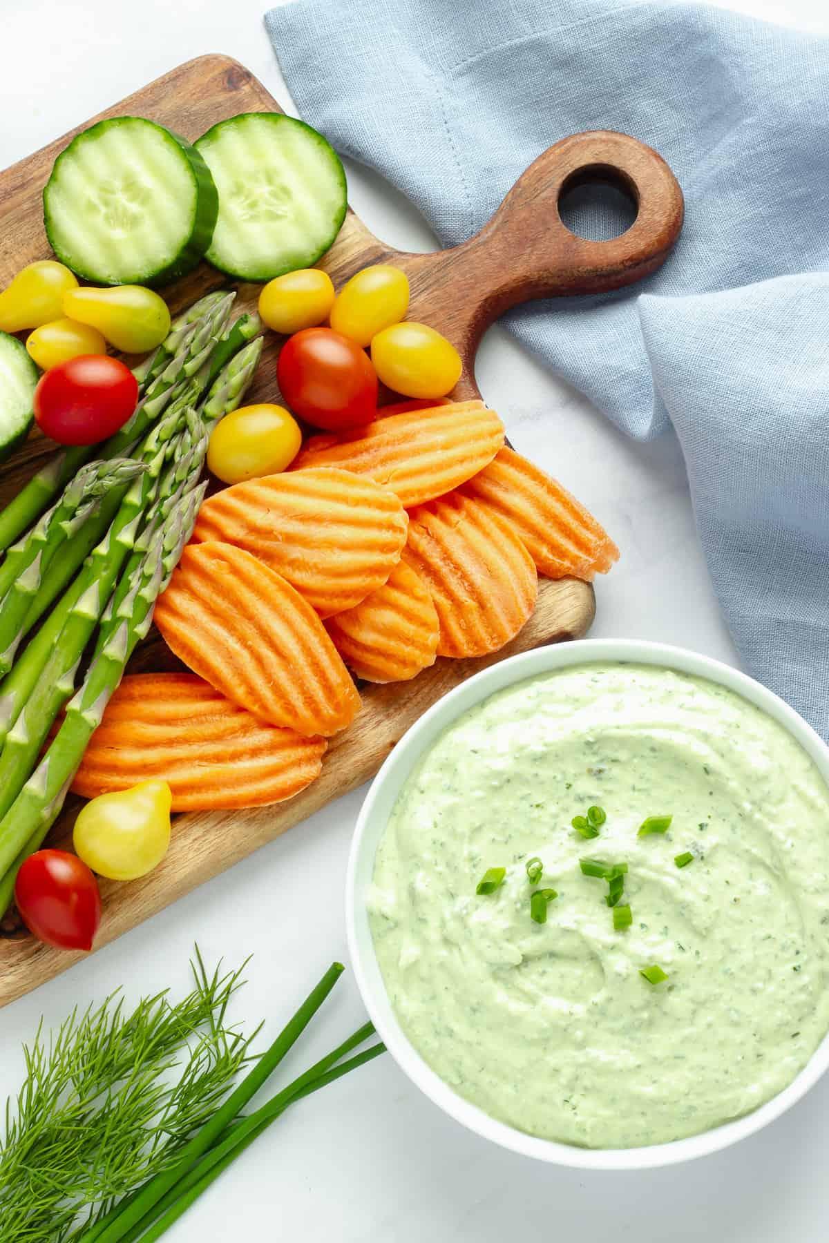 vibrant green goddess dip with fresh vegetables