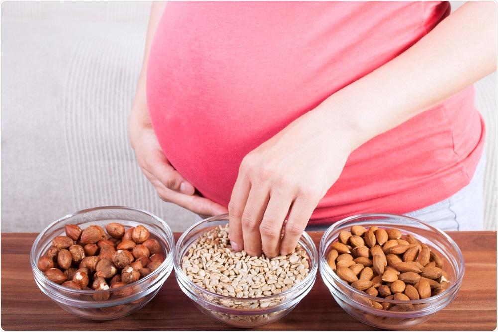 pregnant woman eating nuts and seeds