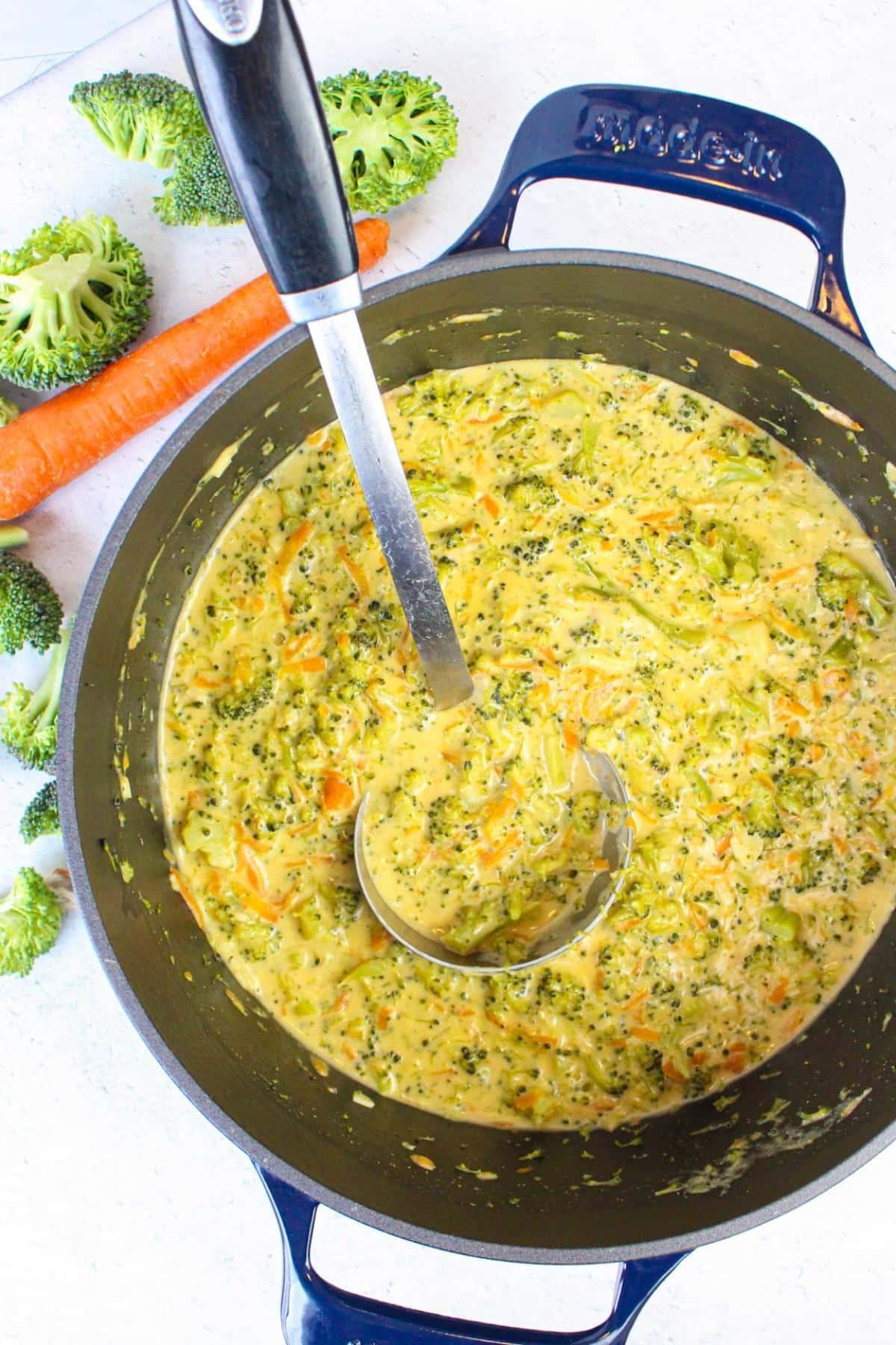 pot of vegan cheddar broccoli soup simmering on the stove