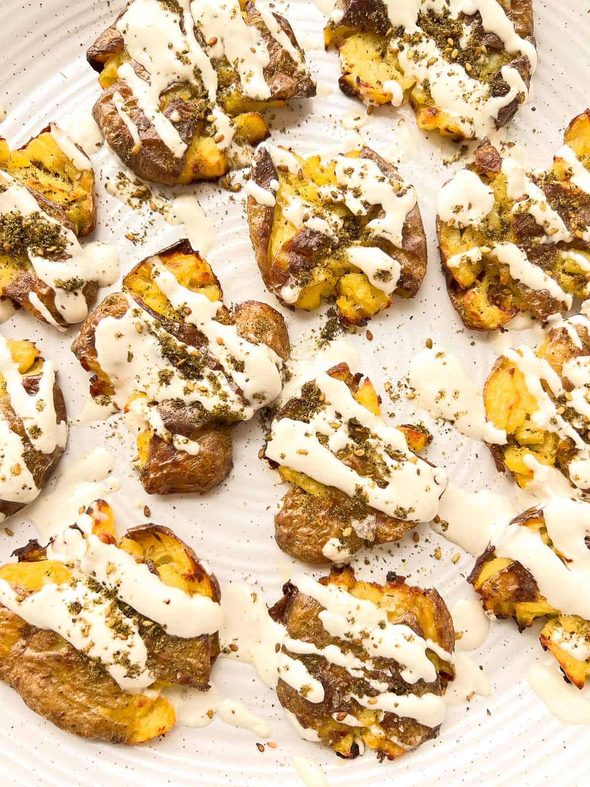 Close up of Jordanian Shawarma with Za'atar-Crusted Potatoes, steam rising, garnished with fresh herbs and tahini